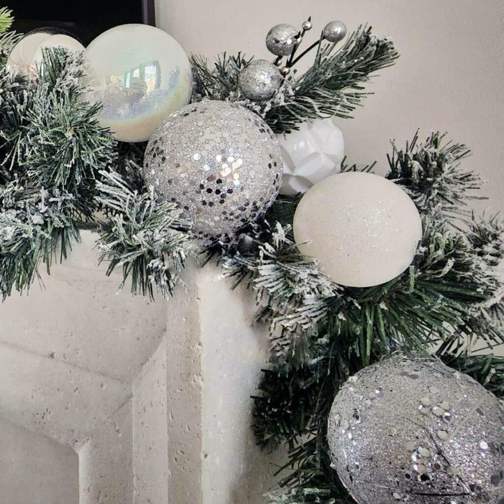 Christmas mantle garland decor by Caitlin Ruth in white, glitter and glass balls in a modern home in Buckhead